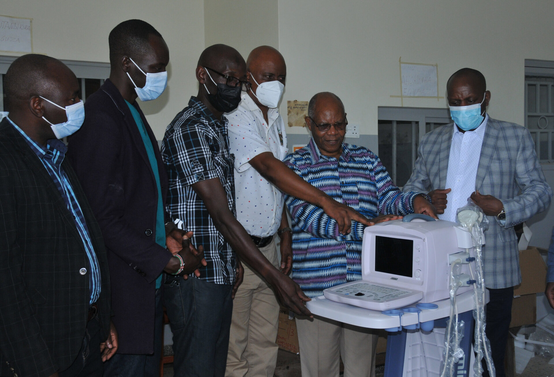 Johnson Bitarabeho (2nd right) the Chairperson of Rukararwe board of trustees handing over the ultrasound scan machine to authorities of Bushenyi-Ishaka Municipality recently. Rukararwe acquired the machine from members of Kronshagen-Bushenyi Municipalities (KroBu) Association in Germany. KroBu is partnering with Bushenyi/Ishaka Municipality to implement a number of activities especially in the environment.